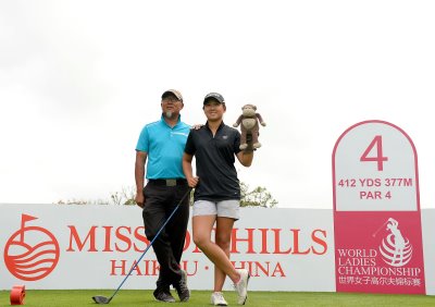 HAIKOU- HAINAN ISLAND-CHINA- Yan Jing of China, right, pictured with Yan Ming, her father/caddie on the 4th tee box on Thursday, March 10, 2015, during an official practice round of the World Ladies Championship at the Blackstone Course, Mission Hills Golf Resort Haikou, Hainan Island, China. The USD$ 600.000 event is staged March 12-15, 2015. Picture by Paul Lakatos/Mission Hills.