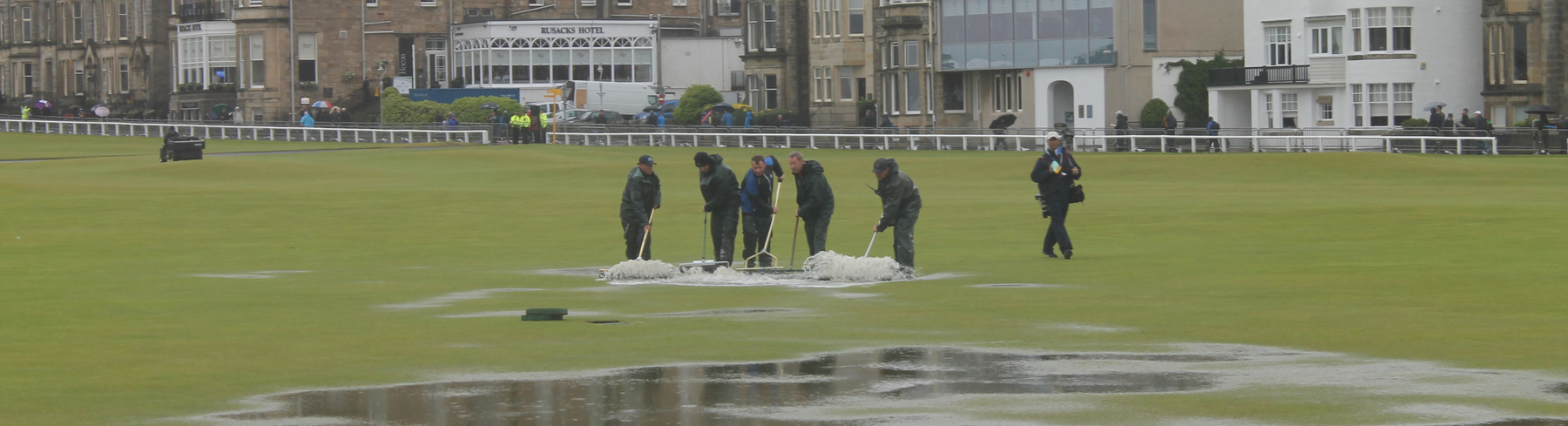 Greenkeepers clear rainwater from the Old Course, July 2015
