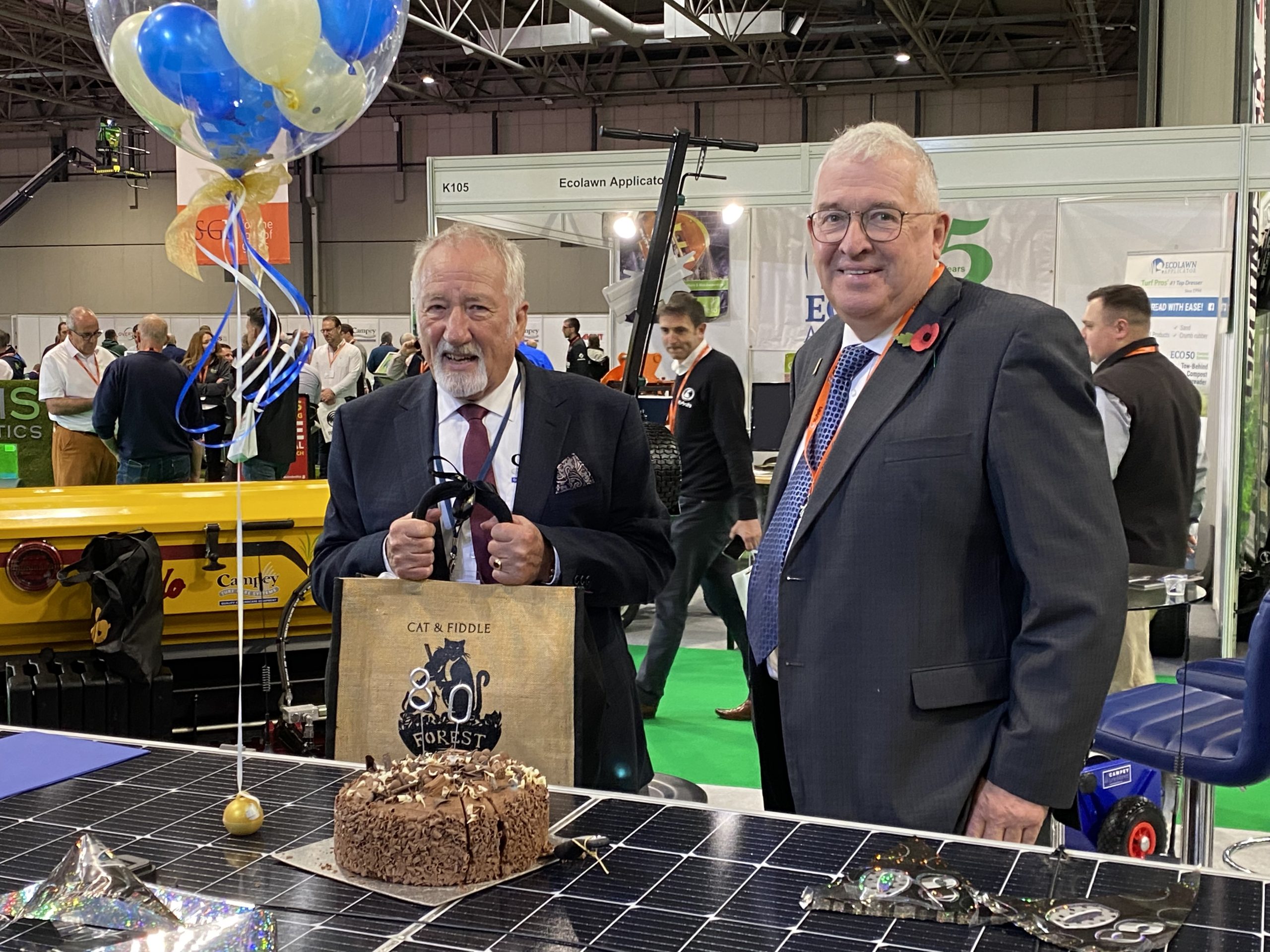 Richard Campey presents Ian Pogson with 80th birthday gift at Saltex 2022