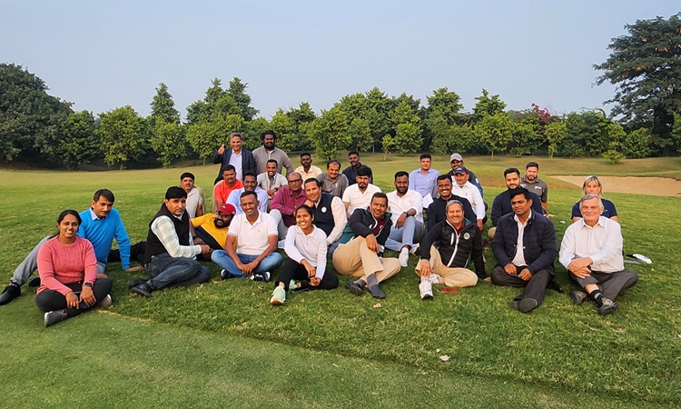 CIG group photo on the golf course header