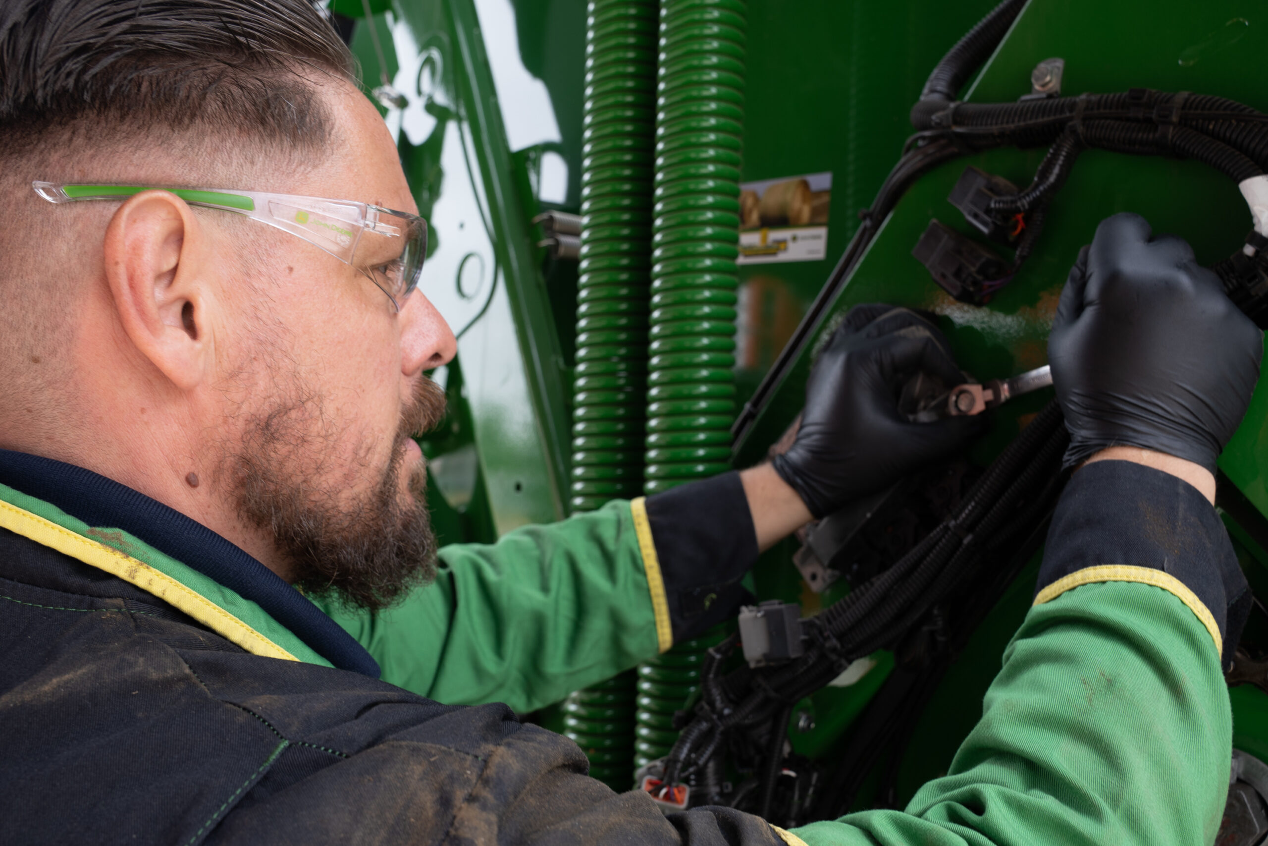 A technician working on a John Deere machine