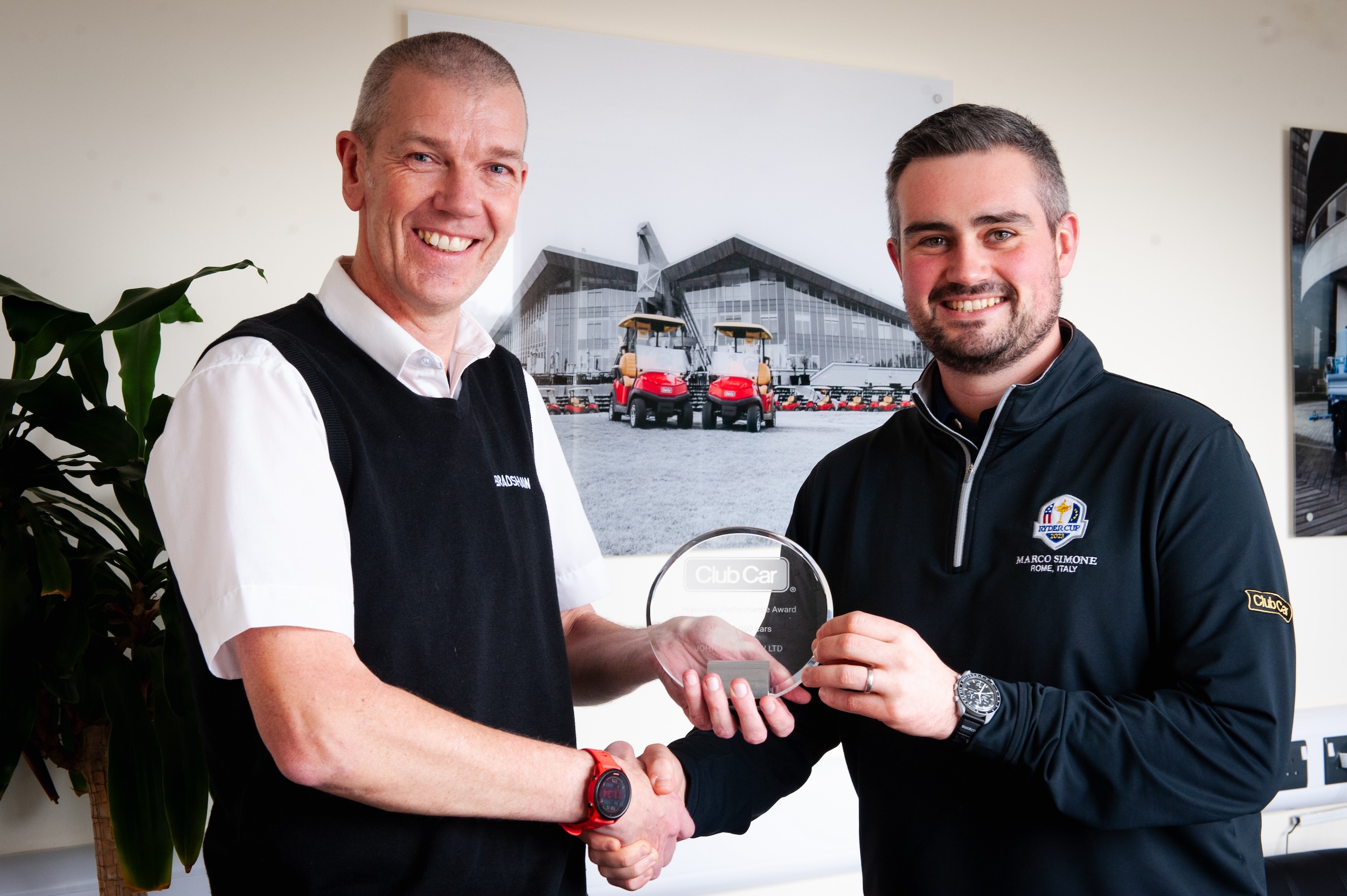 Drew Bradshaw, Joint Managing Director at Bradshaw EV, (left) receiving the award from Andy Bourke (right), Regional Sales Manager at Club Car