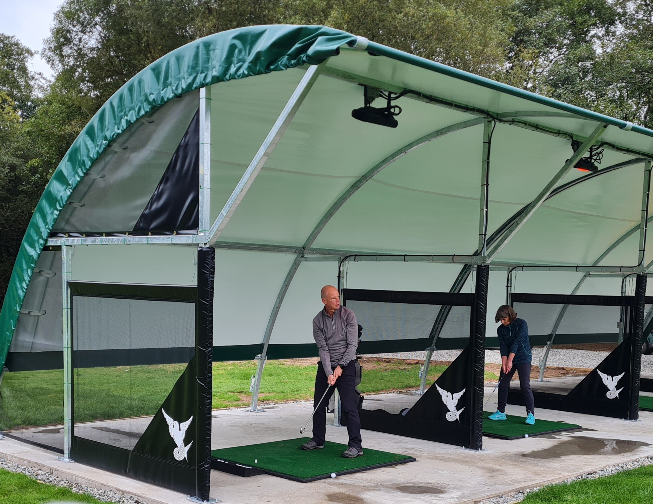 Golfers trying out the all weather driving range